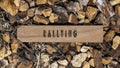 rallying sports. Written on wooden surface. Wooden frame on pieces of stone. Sports and adventure