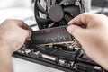 Installing random access memory into PC.