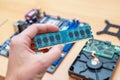 RAM memory module in hand. Motherboard and hard disk in background Royalty Free Stock Photo