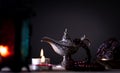 Ramadan food and drinks concept. Ramadan Lantern with arabian lamp, wood rosary, tea, dates fruit and lighting on a wooden table Royalty Free Stock Photo