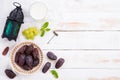 Ramadan food and drinks concept. Ramadan Lantern with Milk, dates fruit, grape and Mint leaves on a white wooden table background Royalty Free Stock Photo