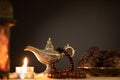 Ramadan food and drinks concept. Ramadan Lantern with arabian lamp, wood rosary, tea, dates fruit and lighting on a wooden table Royalty Free Stock Photo