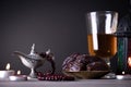 Ramadan food and drinks concept. Ramadan Lantern with arabian lamp, wood rosary, tea, dates fruit and lighting on a wooden table Royalty Free Stock Photo