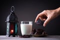 Ramadan food and drinks concept. Woman hand reaches out to a plate with date with Ramadan Lantern with arabian lamp, wood rosary,