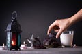 Ramadan food and drinks concept. Woman hand reaches out to a plate with date with Ramadan Lantern with arabian lamp, wood rosary,