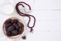 Ramadan food and drinks concept. Wood rosary, milk and dates fruit on a white wooden table background. Top view, Flat lay Royalty Free Stock Photo