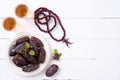 Ramadan food and drinks concept. Wood rosary, tea and dates fruit on a white wooden table background. Top view, Flat lay Royalty Free Stock Photo