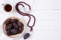 Ramadan food and drinks concept. Wood rosary, tea and dates fruit on a white wooden table background. Top view, Flat lay Royalty Free Stock Photo