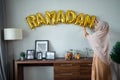 Ramadan gold balloon text on the wall