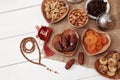 Ramadan iftar party concept. Islamic holy book Quran and rosary beads with delicious dates, dried figs, dried apricots, walnuts, a