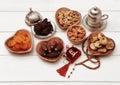 Ramadan iftar party concept. Islamic holy book Quran and rosary beads with delicious dates, dried figs, dried apricots, walnuts, a Royalty Free Stock Photo