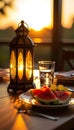 Ramadan Iftar Table with Glowing Lantern Water Glass and Fresh Fruit at Sunset Royalty Free Stock Photo