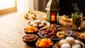 Ramadan Iftar table setting with dates, dried apricots, nuts, and Arabic sweets under a decorative lantern. Royalty Free Stock Photo