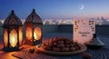 Ramadan iftar table setting with lanterns dates and cityscape at twilight with crescent moon Royalty Free Stock Photo