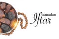 RAMADAN IFTAR text with Dates or kurma fruits and rosary beads or Tasbih on white background.
