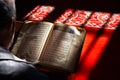 Ramadan or islamic concept photo. Muslim man reads the Holy Quran in a mosque