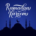 Ramadan Kareem calligraphy lettering and silhouette of mosque against night sky. Muslim holy month concept. Vector Royalty Free Stock Photo