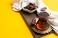 Ramadan Kareem Festival, close up of dates at bowl with rosary and cup of black tea on yellow background