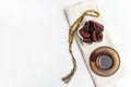 Ramadan Kareem Festival, Dates on wooden bowl with cup of black tea and rosary on white isolated background