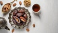 Ramadan Kareem greeting card design. Dried dates in Islamic star and crescent moon plate, nuts, oriental lantern, cup of tea on