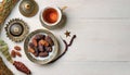 Ramadan Kareem greeting card design. Dried dates in Islamic star and crescent moon plate, nuts, oriental lantern, cup of tea on