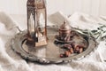 Ramadan Kareem greeting card, invitation. Bronze glowing Moroccan lantern on linen table cloth. Silver plate with dates