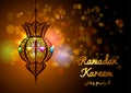 Ramadan Kareem greeting card with a silhouette of Arabic lamp and hand drawn calligraphy lettering on abstract colorful background
