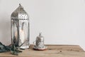 Ramadan Kareem, iftar dinner still life. Ornamental silver lantern with candle and cup with Turkish tea or coffee. Green