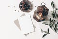 Ramadan Kareem mockup. Bronze plate with dates fruit, olive branches, glowing Moroccan lanternand blank greeting card on