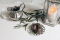 Ramadan Kareem still life. Closeup of glowing lantern, olive tree branches, silver jug and date fruit, silver tray