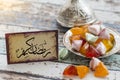 Ramadan kerim text in arabic on vintage table with candies Royalty Free Stock Photo