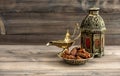 Ramadan lamp and dates on wooden background. Oriental lantern