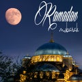 Ramadan mubarak or Ramazan Kareem. Full moon over Istanbul's New Mosque. Ramadan mubarak text in the image.