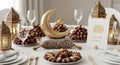 Ramadan Mubarak table setting with dates and decorations on white tablecloth Royalty Free Stock Photo