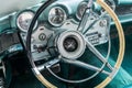 Vintage Lincoln Continental car interior - steering wheel with logo and dashboard