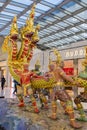 Ramayana traditional Angel captured Thai serpent or Naga sculpture statue in departure area of Suvarnabhumi International Airport