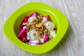 Rambutan, dragon fruits, multigrain, and granola with yogurt in green bowl for healthy breakfast