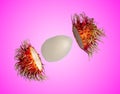 Rambutan isolated from the shell on the pink blackground.