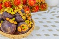 Mangosteen and rambutan on a white table.