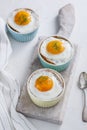 Ramekins baked eggs on white background, top view Royalty Free Stock Photo