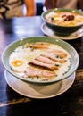 Ramen Cream Pork Bone Soup Tonkotsu Ramen with Chashu Pork, Scallion, Sprout, Onion, Menma and Dried Seaweed and boiled egg Royalty Free Stock Photo