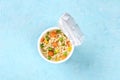 Ramen cup, instant noodles in a plastic cup, shot from above with a place for text Royalty Free Stock Photo