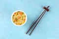 Ramen cup, instant noodles in a plastic cup, overhead shot with chopsticks and a place for text Royalty Free Stock Photo