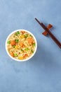 Ramen cup, instant soba noodles in a plastic cup, overhead shot with chopsticks Royalty Free Stock Photo