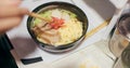 Ramen food, plate and table in restaurant with person, hands and ginger with closeup for Japanese cuisine. Niboshi bowl