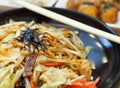 RAMEN: Japanese style fried noodle with chicken squid fresh vegetable and sesame oil Royalty Free Stock Photo