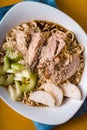 Ramen noodle soup, celery, chicken on a yellow table closeup Royalty Free Stock Photo