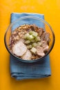 Ramen noodle soup, celery, chicken on a yellow table side view