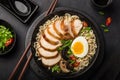 ramen noodle soup with chicken, shiitake mushroms and egg in black bowl