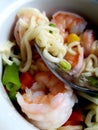 Ramen noodle variation with carrot, pea and shrimp.